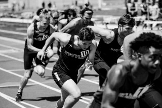 runners on track in black and white