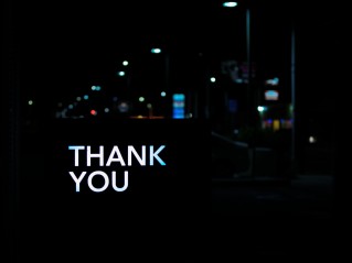 thank you written against dark city background